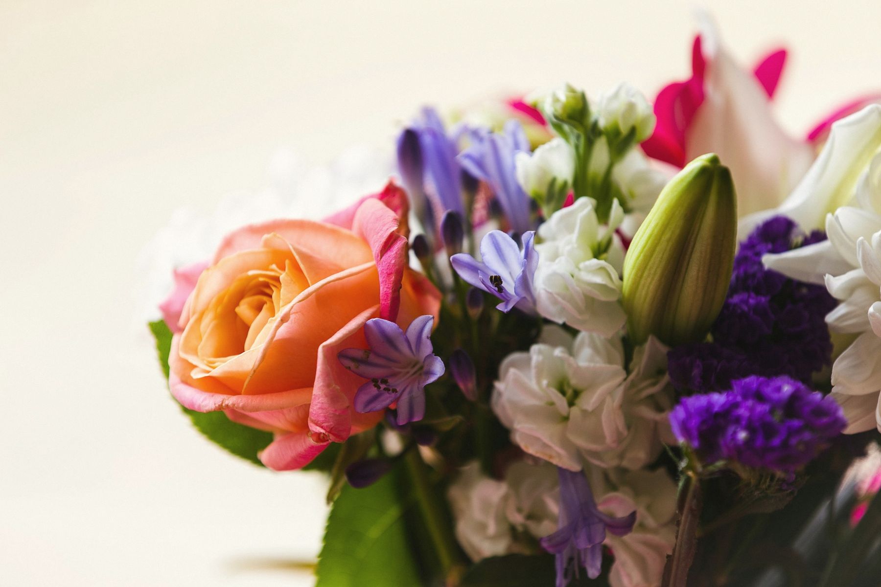 A loose spring bouquet of roses, irises and lilies